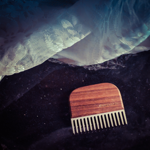 Beard comb in oiled walnut and blasted stainless steel.