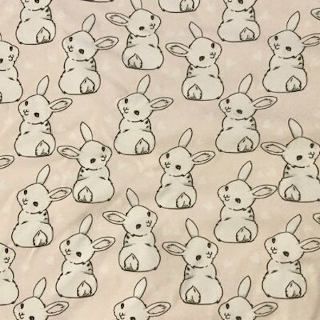 Kaniner på ljusrosa bakgrund Bomullsjersey