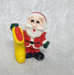 Porslins tomte äldre med strumpa