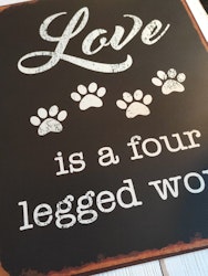 Plåtskylt, "Love is a four legged......"