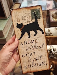 Plåtskylt, "A home without a cat....."