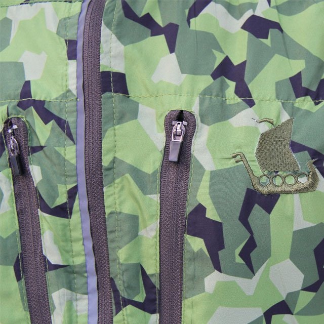 Close up of breast pockets zippers and embroidered logo.