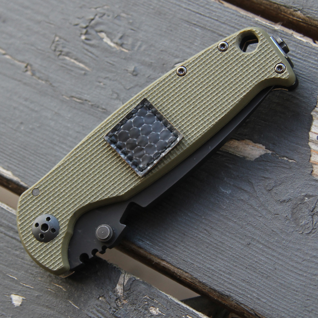 One IR Tactical Glint Square - 2 cm placed on a knife for size comparison.