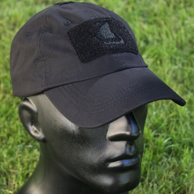 Green grass background of photoshoot of the Baseball Cap Black.