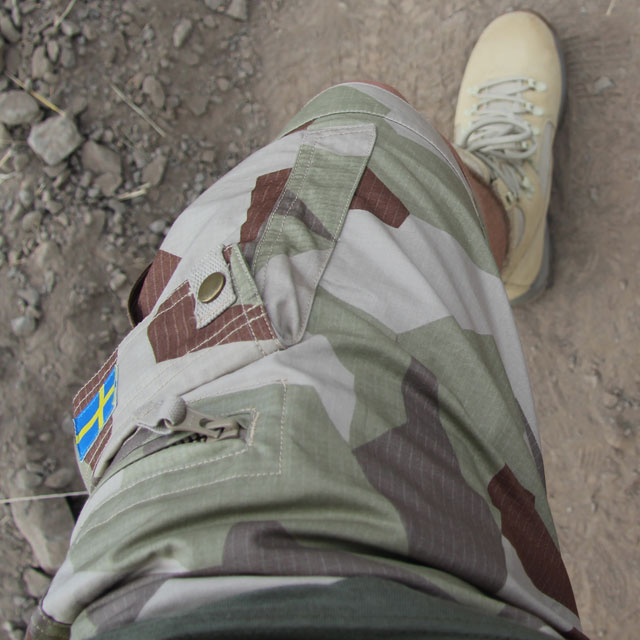 Camp Shorts M90K Desert photo showing left leg from above with desert type nature in the background.