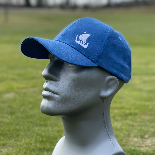 A Baseball Cap Blue from TAC-UP GEAR on a mannequin seen from the side showing the viking ship embroidery
