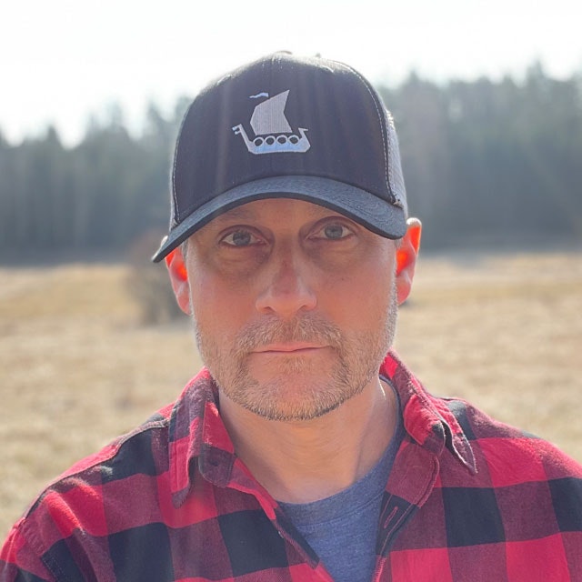 Mesh Cap Black and Grey from TAC-UP GEAR seen from the front on man in red and black. shirt