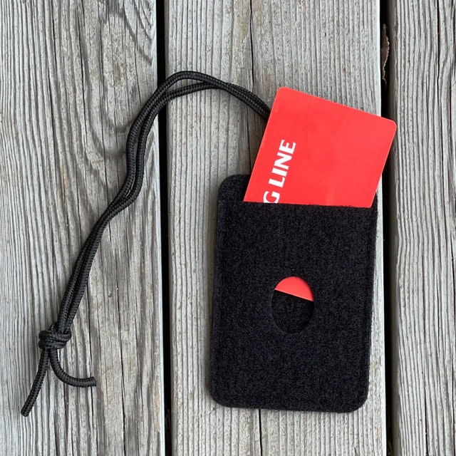 A Card holder Hook and Loop Black with a red card in it
