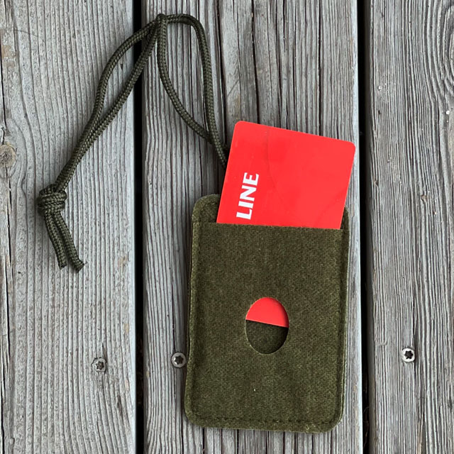 A Card holder Hook and Loop Green with a red card in it