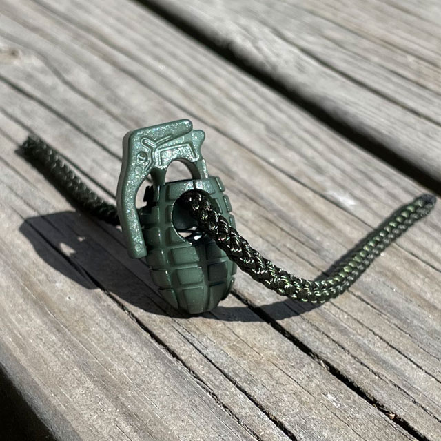 A Cord Lock Grenade Green from TAC-UP GEAR seen with a string