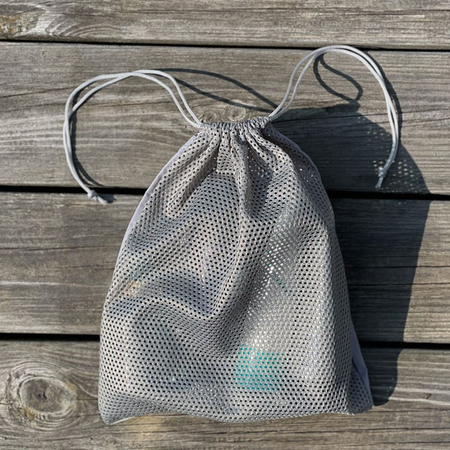 The netting side seen on a filled Drawstring Net Pouch Grey from TAC-UP GEAR