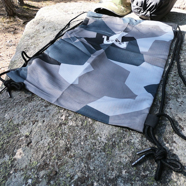 A flat and empty Drawstring Sports Bag M90 Grey are waiting to be filled for photoshoot