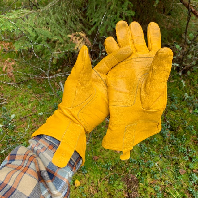 Bushcraft Leather Gloves with thew Swedish forest as background