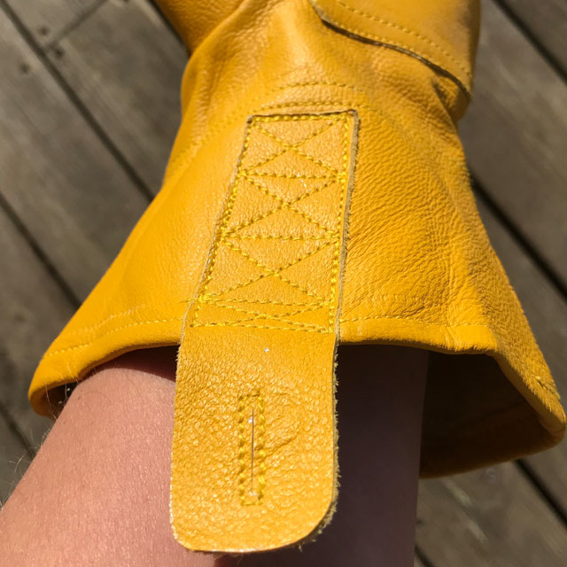 Wrist hanger on a yellow goatskin Bushcraft Leather Glove.