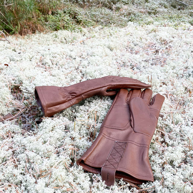 Swedish forest floor with white moss and a pair of Bushcraft Leather Glove Brown from TAC-UP GEAR