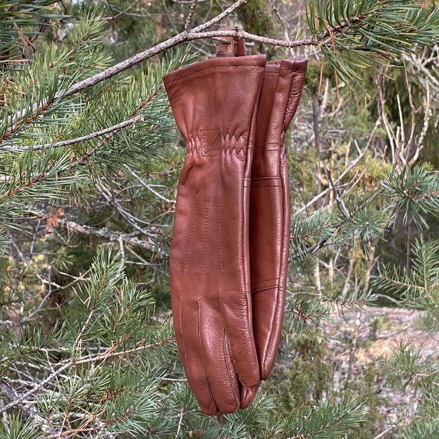 A hanging pair of Bushcraft Leather Glove Brown from TAC-UP GEAR