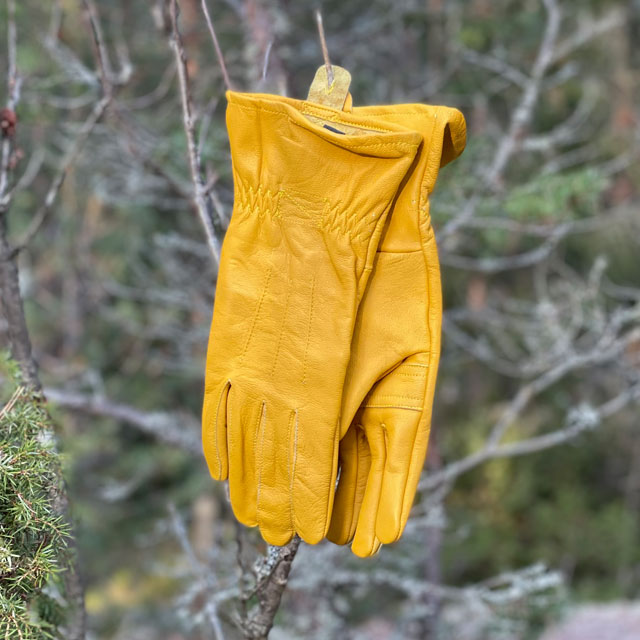 Bushcraft Leather Glove Cavalry from TAC-UP GEAR  hanging as a pair on a tree branch