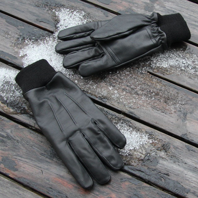 Snow and wood background in photo of a pair Officer Black Leather Gloves.