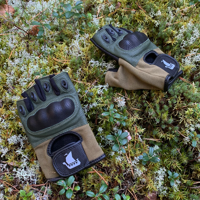 A pair of Short Finger Tactical Glove Green on the forest floor