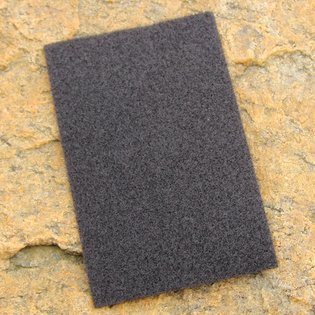A Kardborre Panel 9x14 Greyish Black with rock background for product photo.