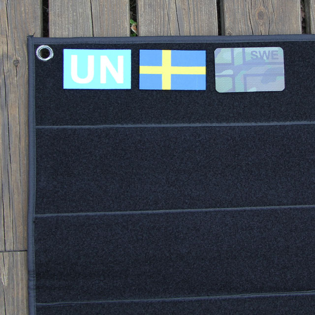 Eyelet and Swedish flag patches on a Kardborre Wall Mat Display Black.