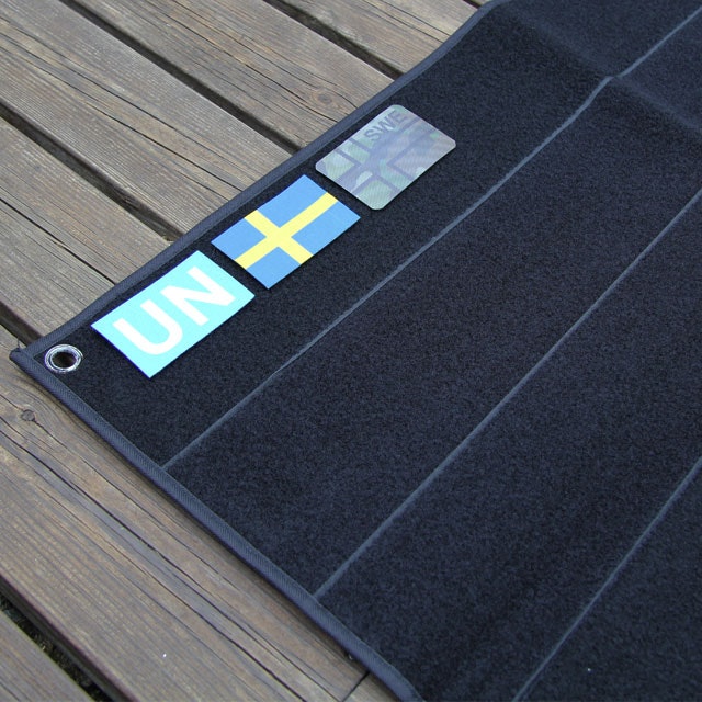 Flag patches on as display on this Kardborre Wall Mat Display Black.