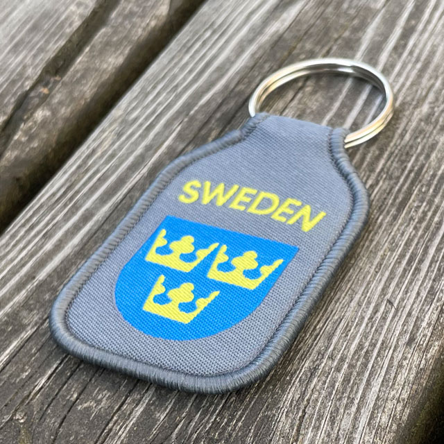 A Keyring SWEDEN Grey from TAC-UP GEAR seen from an angle