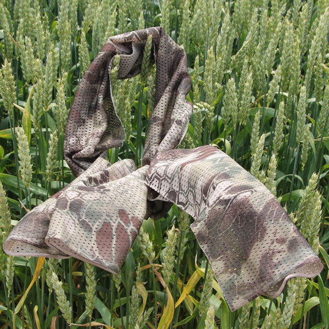 Product photo of a Sniper Scarf Dragon on green summer crop in Swedish nature.
