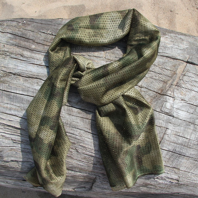 Sniper Scarf Marshland product photo with a dry logg in the background.