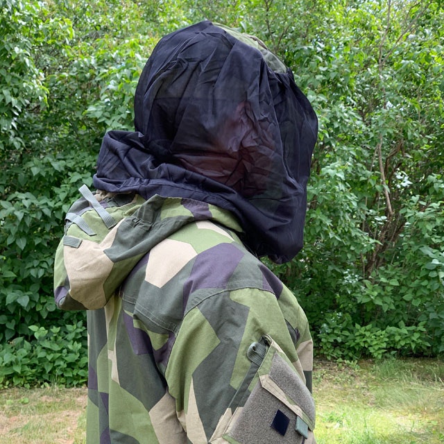 Slightly seen from behind a protective Mosquito Head Net Black/M90