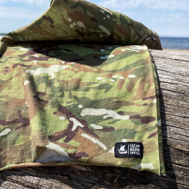 A Multiwrap Coolmax Camo from TAC-UP GEAR seen lying flat on a log