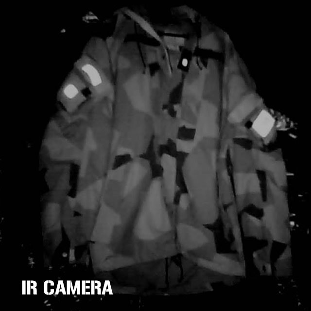 Medium IR light source in a darkened room shone on a NCWR Jacket M90 with IR reflective patches on it