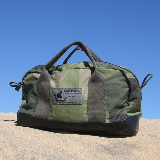 Necessär M90 during photoshoot in the blue sky and sandy desert.