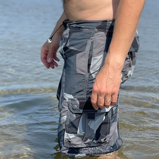 NEPTUNE Shorts M90 Grey worn in the ocean in the sun seen from the side