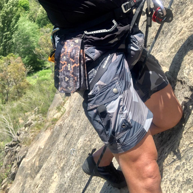 Climber on a rock wall in a pair of NEPTUNE Shorts M90 Grey