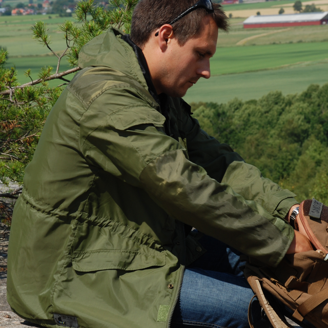 On the look out hill wearing a Nomad Jacket Green.