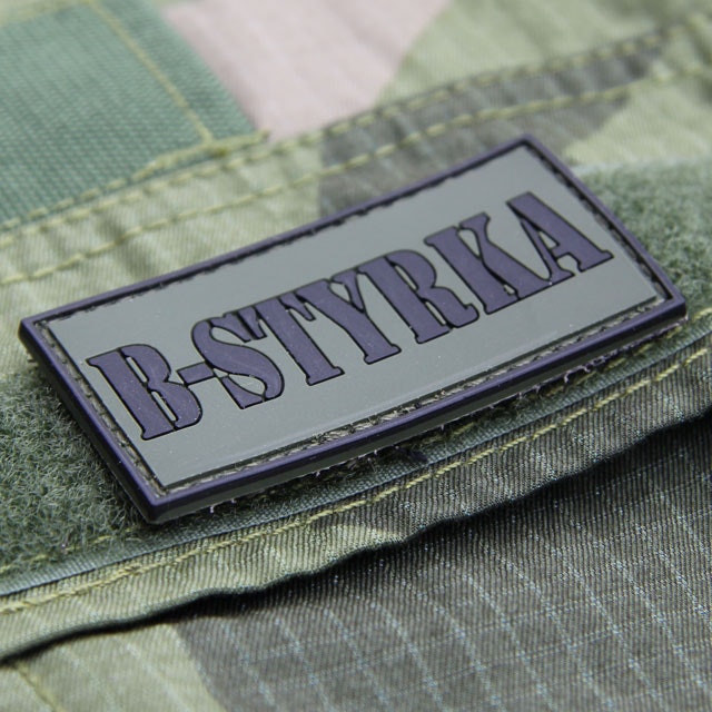 A B-Styrka PVC Patch mounted on the pocket lid of a Field Shirt M90.