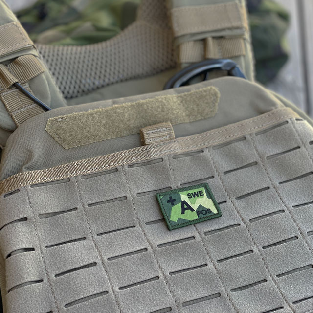An A-POS Blood Type Hook Patch M90 patch from TAC-UP GEAR on a 5.11 plate carrier