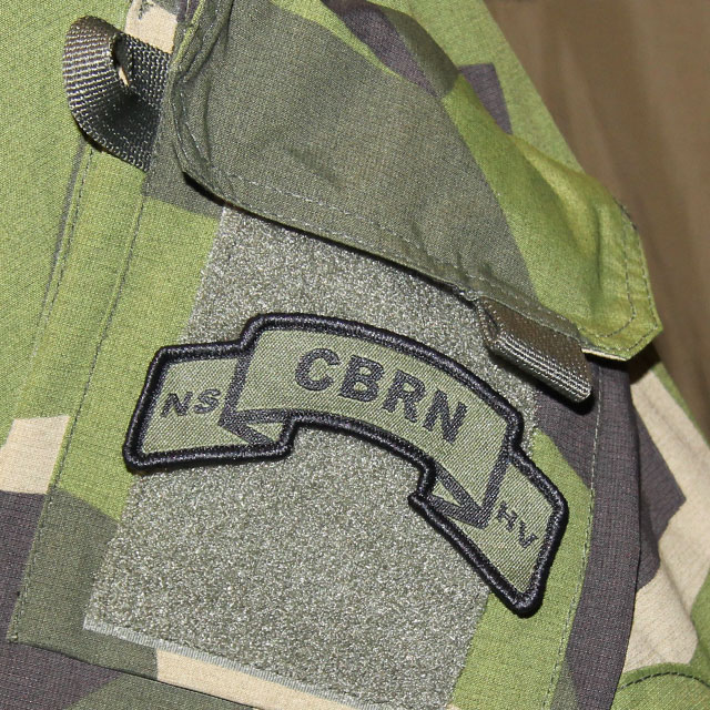 A mounted CBRN Hook Scroll Patch on the arm of a NCWR M90 Jacket.