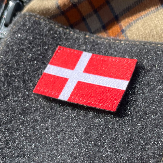 A closer look on a Denmark Flag Hook Patch Small from TAC-UP GEAR mounted on velcro sleeve