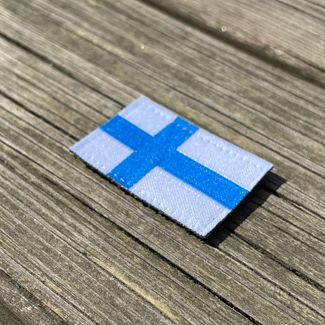 A Finland Flag Hook Patch Small from TAC-UP GEAR seen from an angle