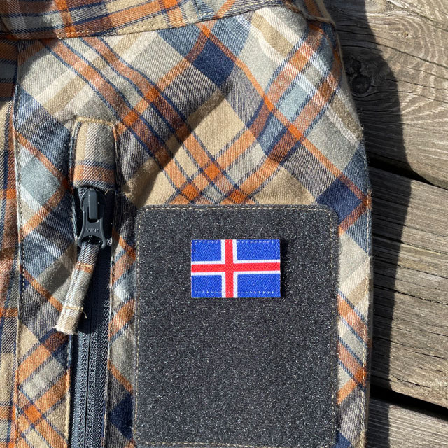 A Iceland Flag Hook Patch Small from TAC-UP GEAR mounted on velcro sleeve on a shirt