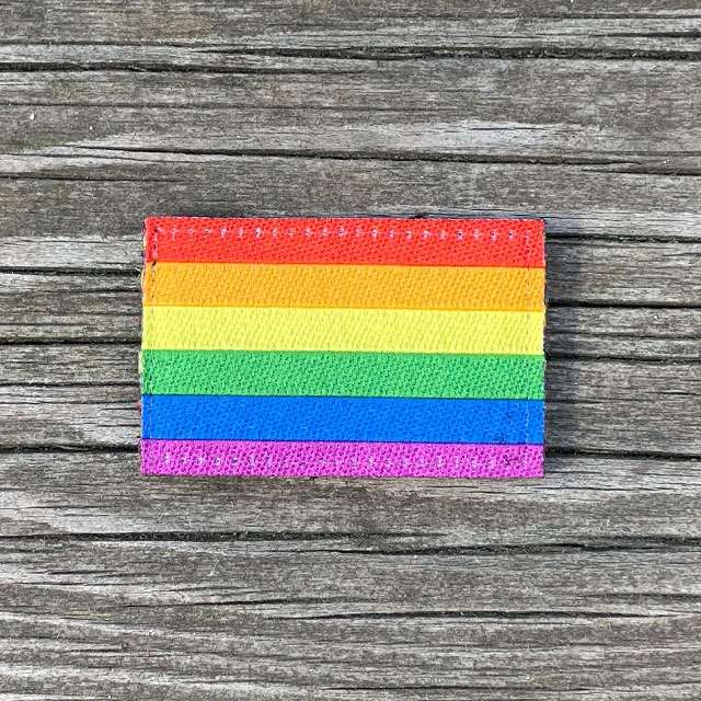 Rainbow Flag Hook Patch Small lying flat on wooded plank