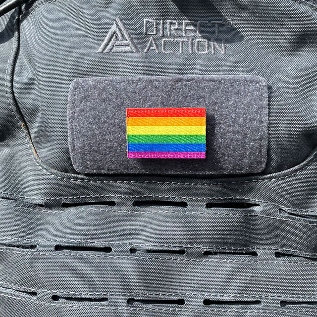 A Rainbow Flag Hook Patch Small lying mounted on a rucksack
