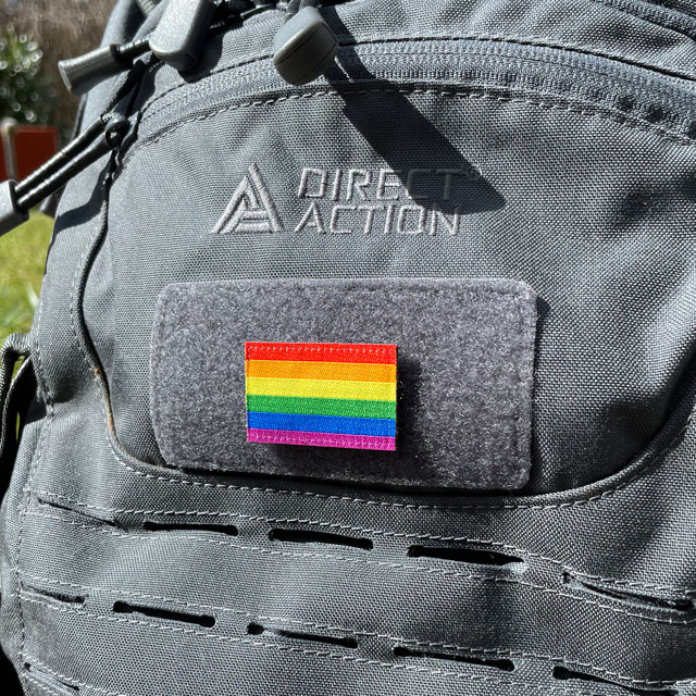 A Rainbow Flag Hook Patch Small lying mounted on a rucksack seen from an angle