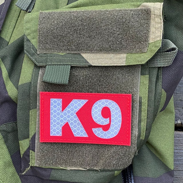 IR - K9 Red Hook Patch mounted on the sleeve of a M90 NCWR Jacket