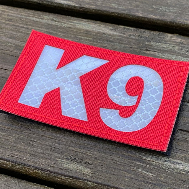 A IR - K9 Red Hook Patch seen slightly from the side