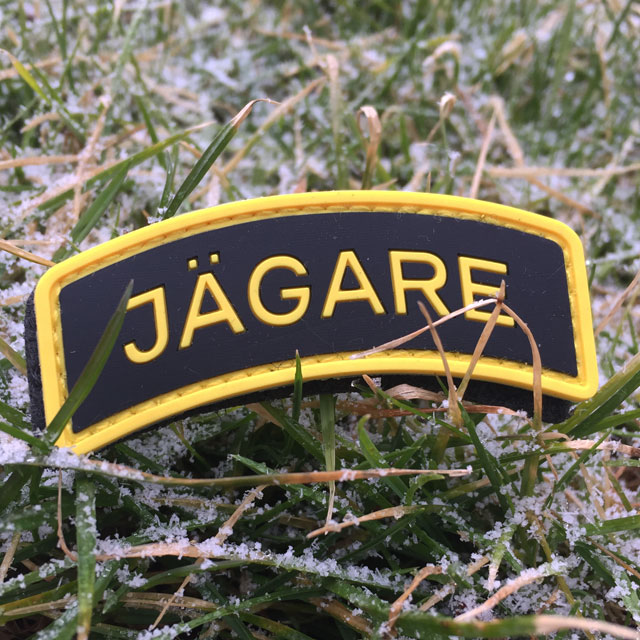 Frosty grass and a JÄGARE Yellow/Black/Yellow PVC Patch.
