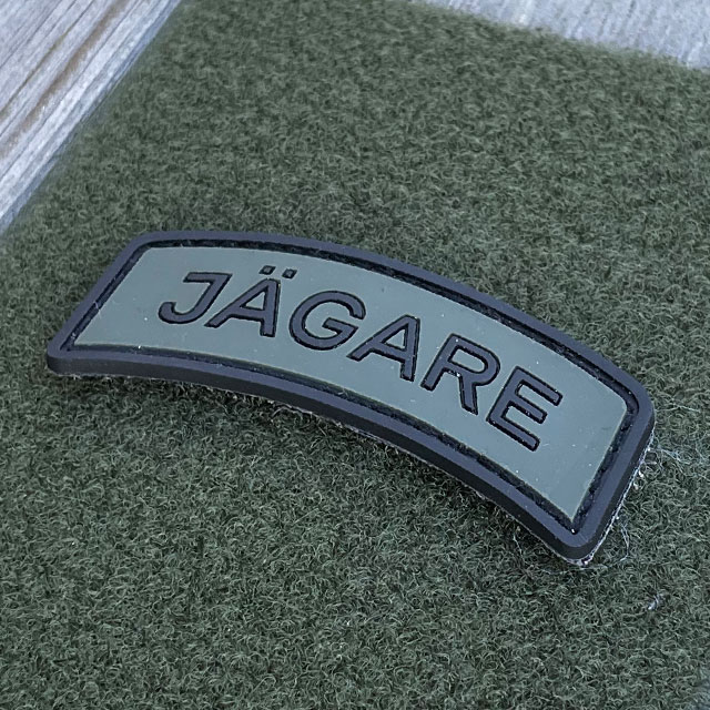 JÄGARE Hook PVC Patch Black/Green seen from an angle