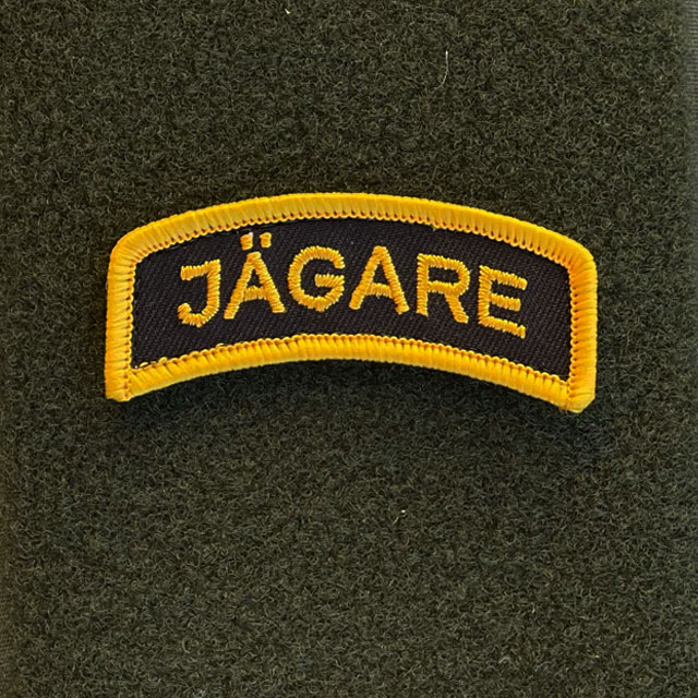 JÄGARE Hook Patch Orange/Black seen from the front mounted on a hook piece